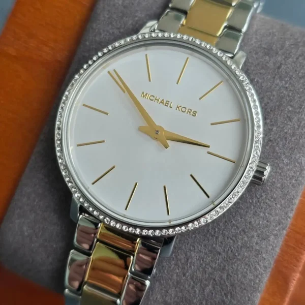 michael-kors-mk1041-pyper-bracelet-acier-bicolore.webp Michael Kors MK1041 Pyper – Montre femme bicolore pavée