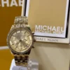 michael-kors-mk7530-bryant-ecrin-original-michael-kors.webp Michael Kors MK7530 Bryant – Mini montre dorée à pierres pavées