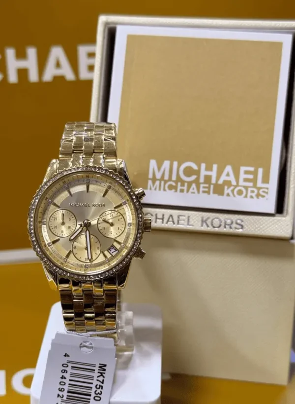 michael-kors-mk7530-bryant-ecrin-original-michael-kors.webp Michael Kors MK7530 Bryant – Mini montre dorée à pierres pavées