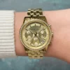 michael-kors-mk7530-bryant-montre-doree-poignet-femme.webp Michael Kors MK7530 Bryant – Mini montre dorée à pierres pavées