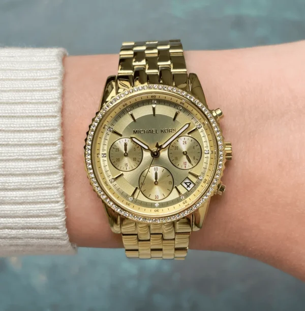 michael-kors-mk7530-bryant-montre-doree-poignet-femme.webp Michael Kors MK7530 Bryant – Mini montre dorée à pierres pavées